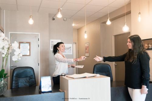 two women playing a game in an office at Résidence New Rochelle in La Rochelle