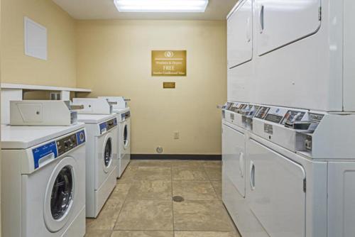 a laundry room with white washers and dryers at Candlewood Suites Destin-Sandestin Area by IHG in Destin
