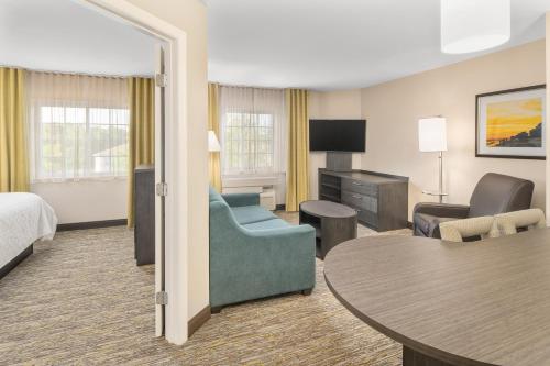 a hotel room with a bed and a table and chairs at Candlewood Suites Destin-Sandestin Area by IHG in Destin