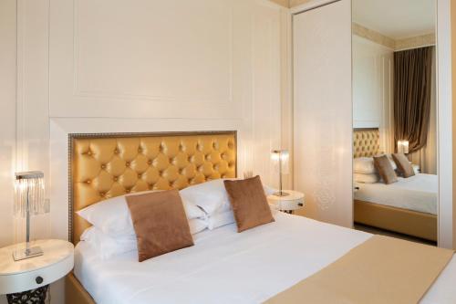 a hotel room with a bed and two beds at Suite Milano Duomo in Milan