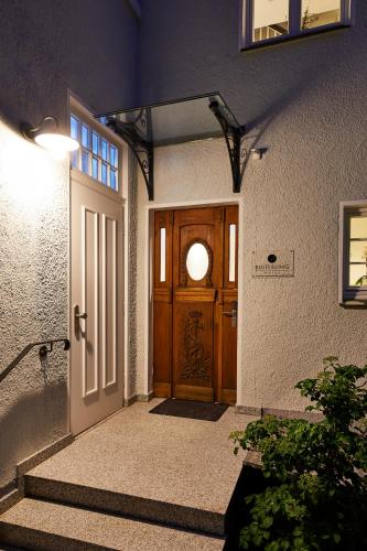 a front door of a house with stairs leading to it at BUITERLING Hotel in Brilon