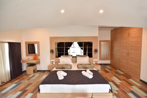 a large bedroom with a large bed and a window at Alesta Midtown in Fethiye