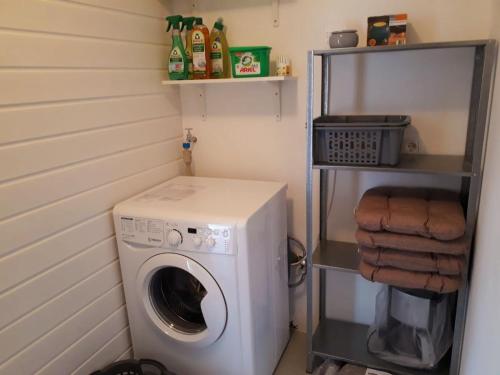 a laundry room with a washing machine and a shelf at Ferienwohnung Neustadt-Wied in Neustadt