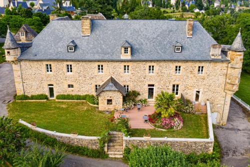 an aerial view of a large stone house at Château de la Falque, The Originals Relais in Saint-Geniez-dʼOlt