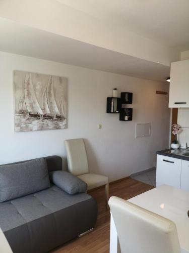 a living room with a couch and a table at Apartments Lorena Mljet in Pomena