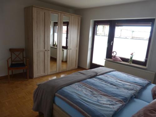 um quarto com uma cama e uma grande janela em Ferienwohnung Lorenzen em Husum