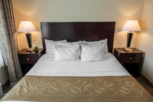 a bed in a hotel room with two lamps at Comfort Suites University Area Notre Dame-South Bend in South Bend