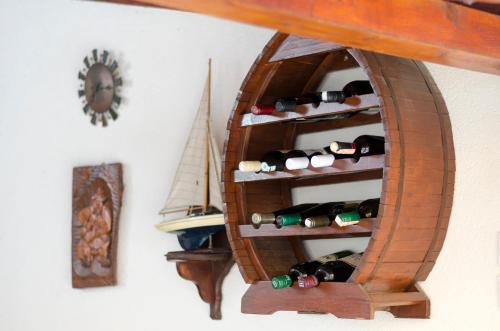 a shelf of wine bottles in a room with a clock at Guest House Time Out in Sarajevo