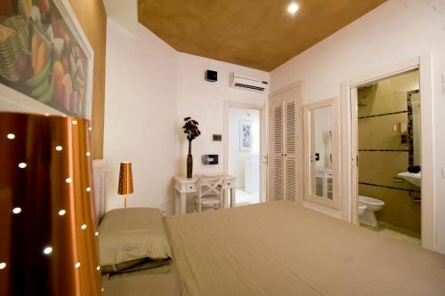 a bedroom with a bed and a bathroom at White House in Trani