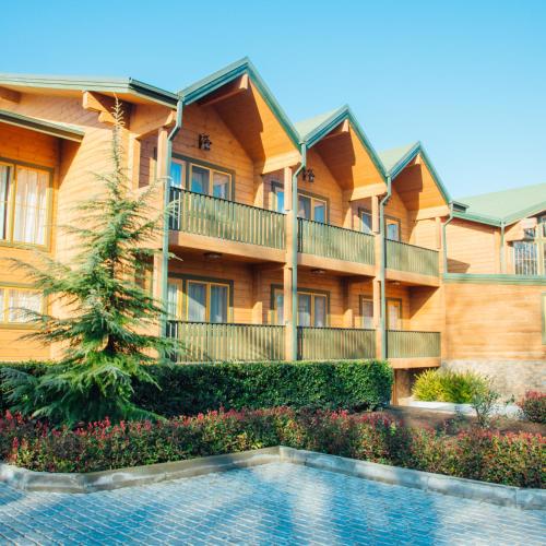 a building with a swimming pool in front of it at RIVER INN RESORT AND SPA in Nabran