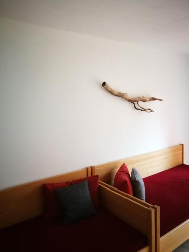 a bedroom with a bed with a log on the wall at Döllelhof Erding in Erding