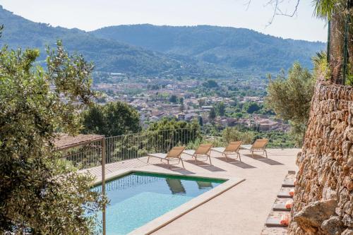 a pool with chairs and a view of a city at Raco de Soller in Sóller