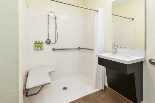 a bathroom with a sink and a shower at Candlewood Suites Rocky Mount by IHG in Rocky Mount
