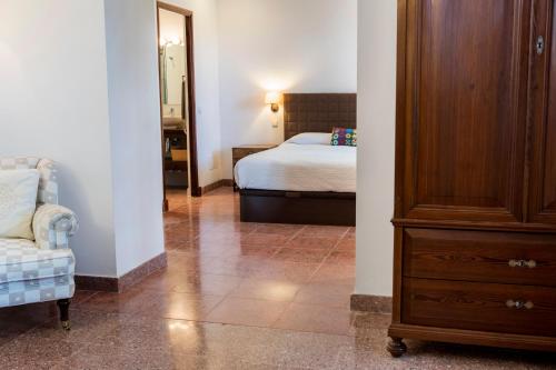 a bedroom with a bed and a dresser in a room at Raco de Soller in Sóller