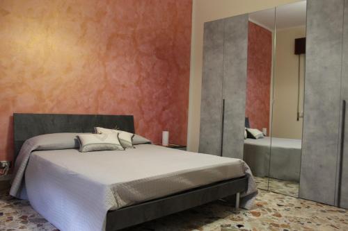 a bedroom with a bed and a mirror and a tub at Taormina Etna Sea in Piedimonte Etneo