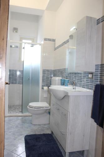 a bathroom with a sink and a toilet and a shower at Taormina Etna Sea in Piedimonte Etneo