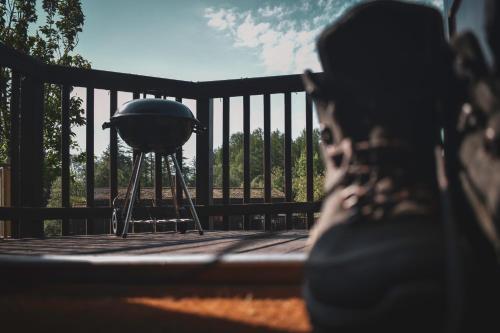 a person sitting on a deck next to a water fountain at Lodge at Loch Lomond in Glasgow