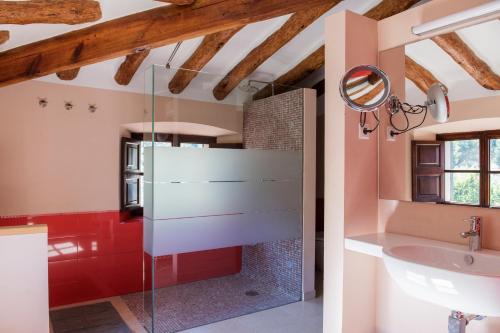 a bathroom with a glass shower and a sink at Raco de Soller in Sóller