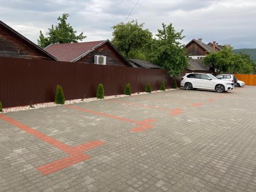 a white car parked in a parking lot with orange arrows at Lex Studio in Praid