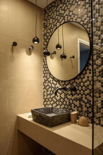 a bathroom with a sink and a mirror at Ambeli Luxury Villa in Megalokhori