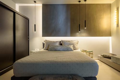 a bedroom with a large bed and a couch at Ambeli Luxury Villa in Megalokhori