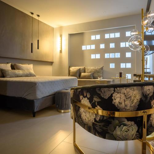 a bedroom with a bed and a tub at Ambeli Luxury Villa in Megalokhori