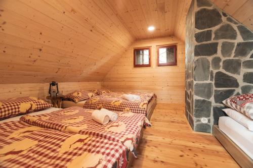 a room with three beds in a log cabin at Velika Planina - Chalet Rušovc - Location with fully privacy in Stahovica