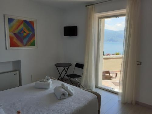 een slaapkamer met een bed en uitzicht op de oceaan bij Il sogno sul lago in Gargnano