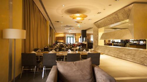 a dining room with a table and chairs and a restaurant at Sundance Hotel Istanbul in Istanbul