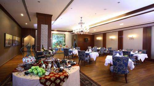 a dining room with tables and chairs and a room with tables and chairs at Sundance Hotel Istanbul in Istanbul