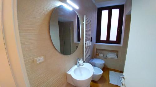 a bathroom with a white sink and a mirror at Stella CasaBono in Sulmona
