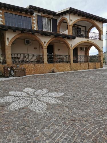 a house with a large flower painted on the ground at Agriturismo Reggia Saracena in Agrigento