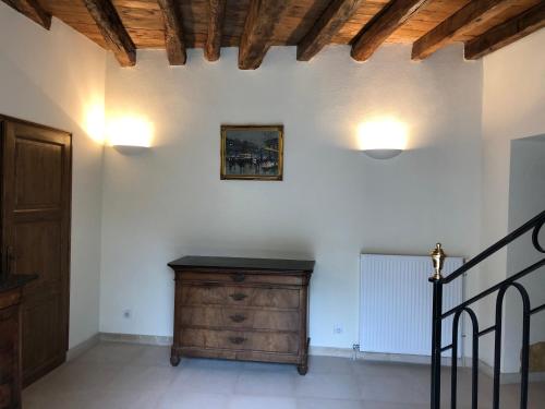 a hallway with a wooden dresser in a room at Hotel La Croix De Vernuche in Varennes Vauzelles