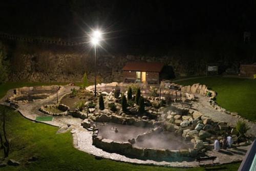 a garden at night with a light on top of it at Motel Cancun Barbadas-Ourense in Os Fornos