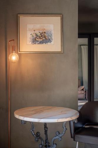 a table in a room with a picture on the wall at Agriresort Villa Gelso- Adults Friendly in Vesime