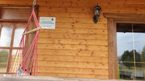 a sign hanging on the side of a wooden building at Kaszuby wczasy u Danusi sauna i bania in Lipusz