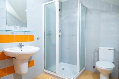 a bathroom with a shower and a toilet and a sink at Nerija in Nida