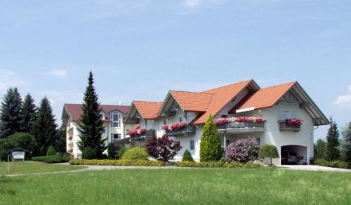 a large house with an orange roof at Haus Panorama in Drobollach am Faakersee