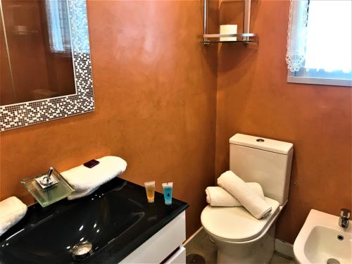 a bathroom with a white toilet and a sink at Levante Trip - Family Apartments in Benidorm