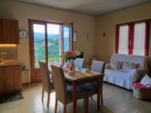 a living room with a table and a couch at CASA MAGIA in Tremosine Sul Garda