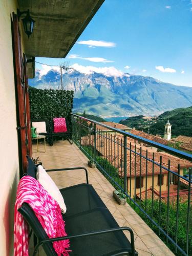a balcony with a couch and a view of mountains at CASA MAGIA in Tremosine Sul Garda