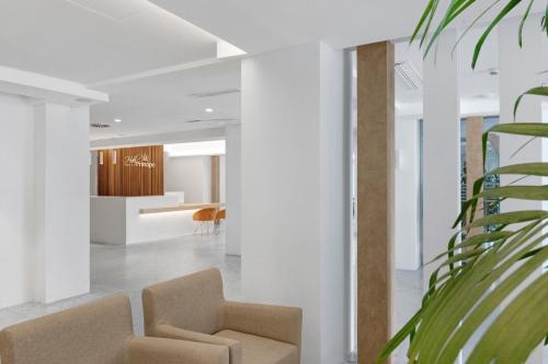 a living room with two chairs and a table at Hotel Principe Wellness&Spa in Playa de Palma
