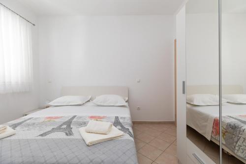 Postel nebo postele na pokoji v ubytování Apartmani Perak