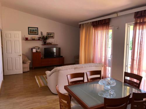 een woonkamer met een tafel en een bank bij Villa Rosso in Baška Voda