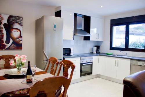a kitchen with a table with a bottle of wine at The Villa by Albir Proper Properties in Albir