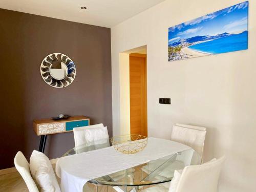 a dining room with a glass table and white chairs at The Villa by Albir Proper Properties in Albir