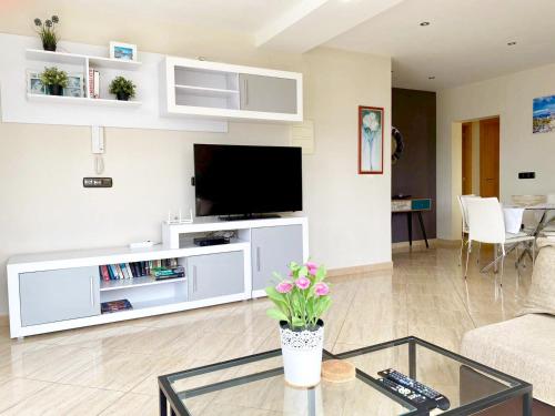 a living room with a tv and a couch at The Villa by Albir Proper Properties in Albir