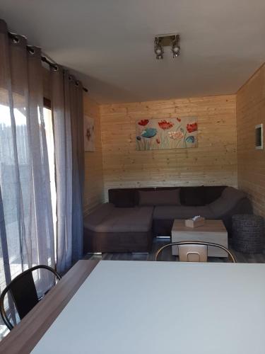 a small living room with a couch and a table at Casute la munte in Râşnov