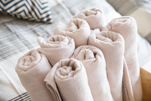 uma pilha de toalhas dobradas numa cama em Cube Haruyoshi Patio - Vacation STAY 83177 em Fukuoka