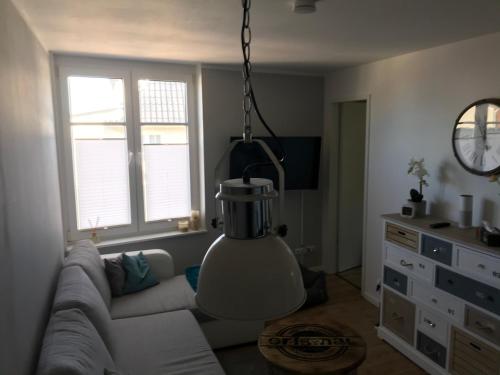 a living room with a couch and a clock at Ferienwohnung Yachthafen Wiek in Wiek auf Rügen